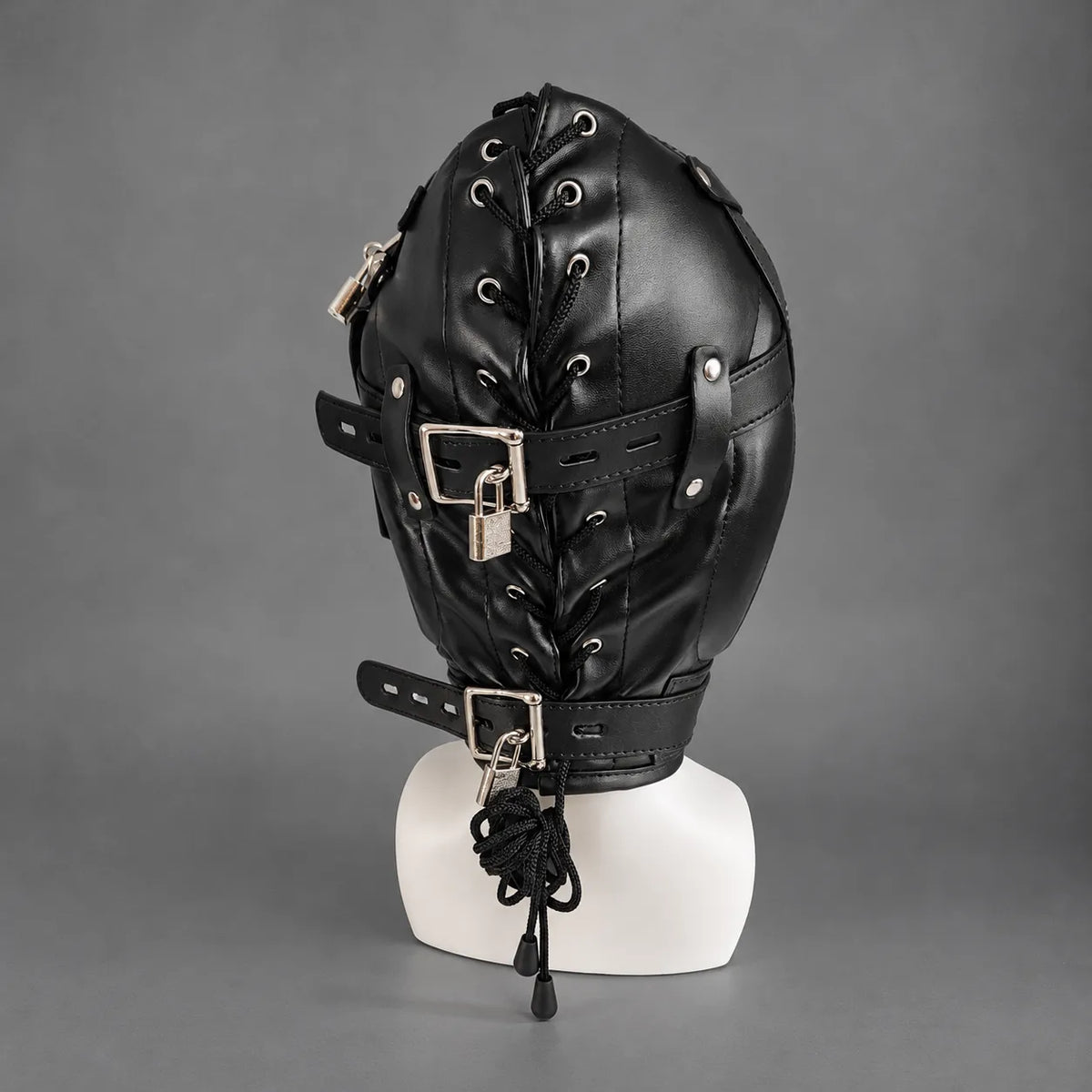Rear side view of a black leather bondage hood with reinforced stitching, adjustable leather straps, metal rivets, and a locking neck collar.