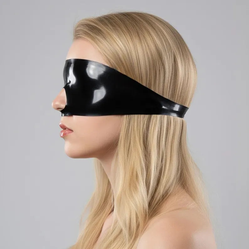 Side profile of a latex blindfold showing the sleek edge finish and facial contouring.
