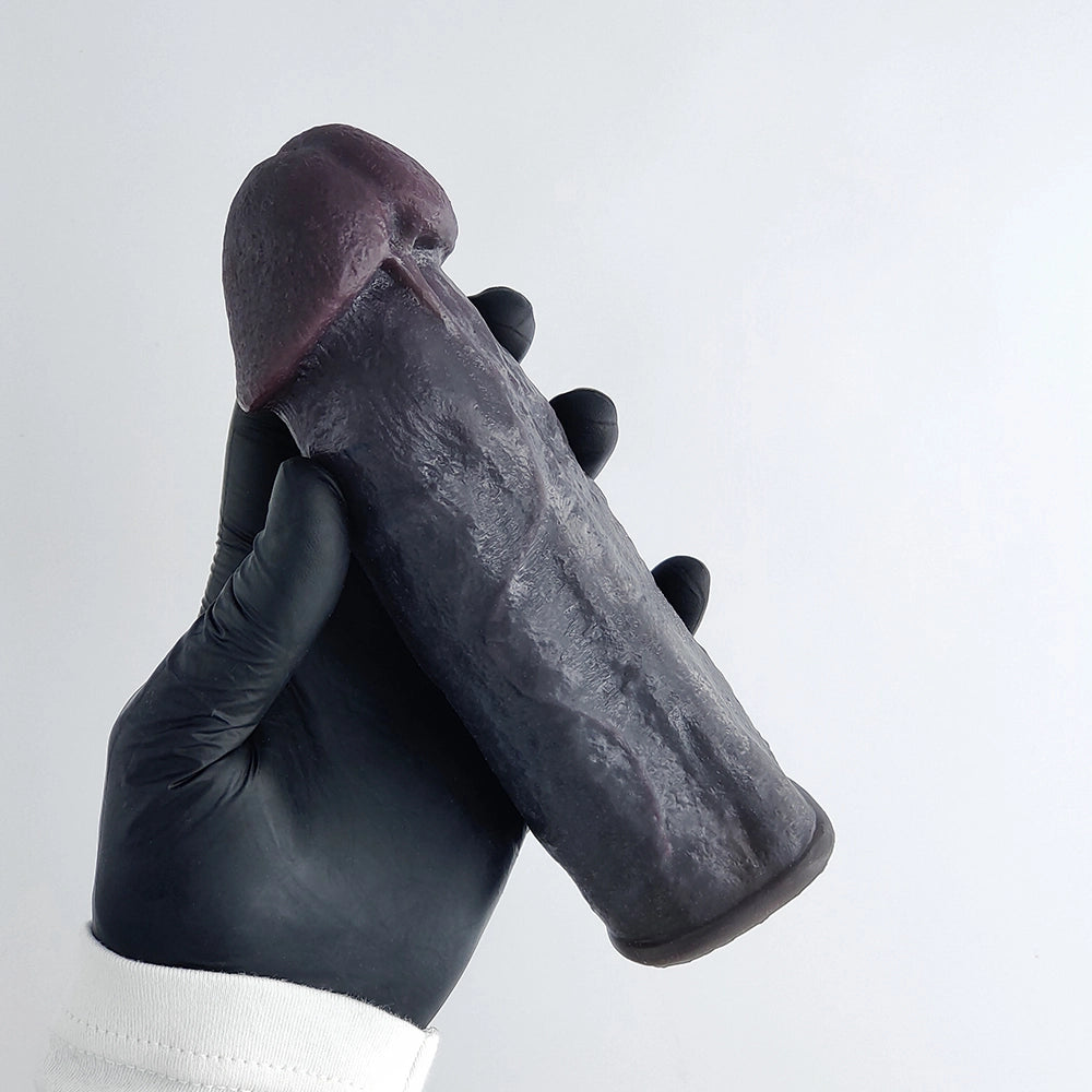 Rear view of realistic black penis sleeve showing frenulum detail
