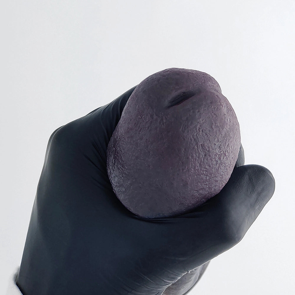 Top view of realistic black penis sleeve tip detail