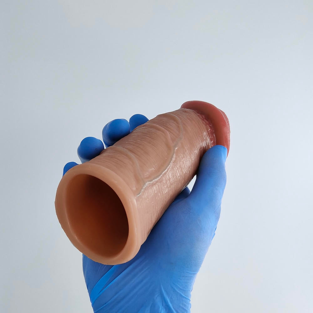 Penis sleeve with mega veins in hand, back view