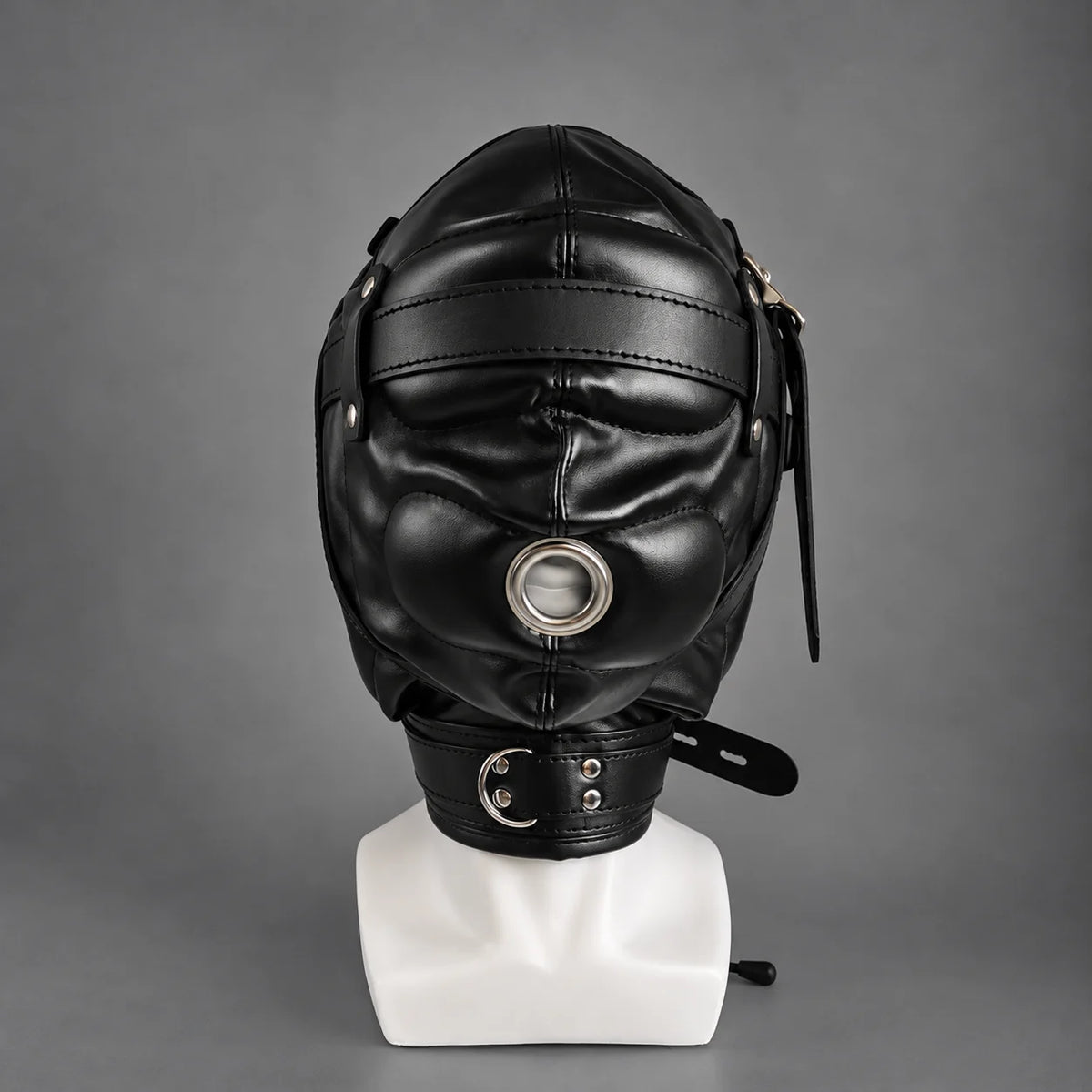 Front view of a black leather bondage hood featuring a circular metal mouth opening, padded eye covering, adjustable side straps, and a leather neck collar.