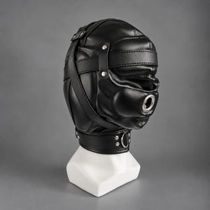 Black leather bondage hood displayed on a mannequin, showing its side profile, metal mouth ring, stitched leather panels, and adjustable neck collar.