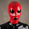 Front view of a tight-fitting red latex full face hood worn by a shiny black mannequin. The mask has precise cutouts for the eyes, nose, and mouth, revealing the mannequin underneath.
