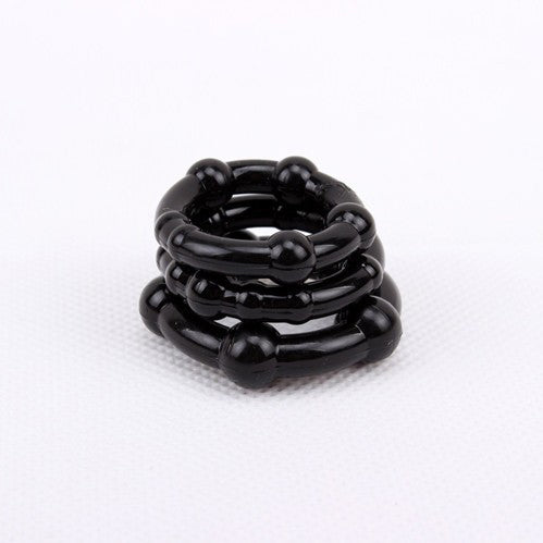 Three black silicone cock rings stacked on top of each other