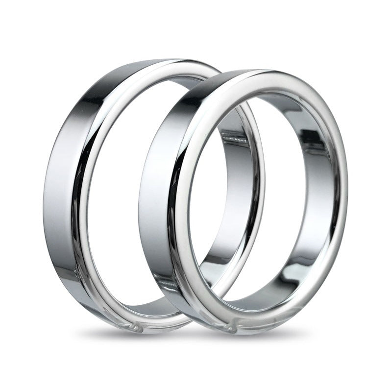 Two polished stainless steel cock rings standing side by side